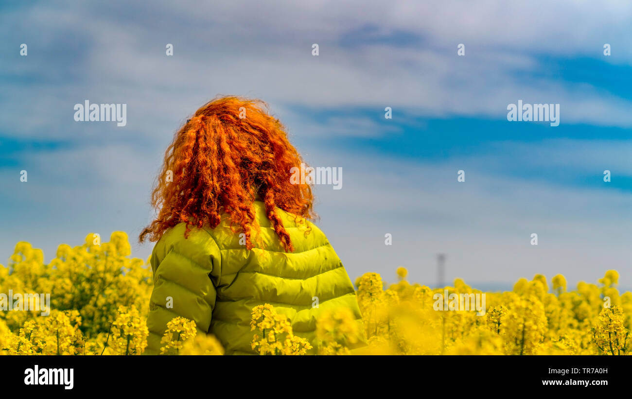 Woman in yellow coat hi-res stock photography and images - Alamy