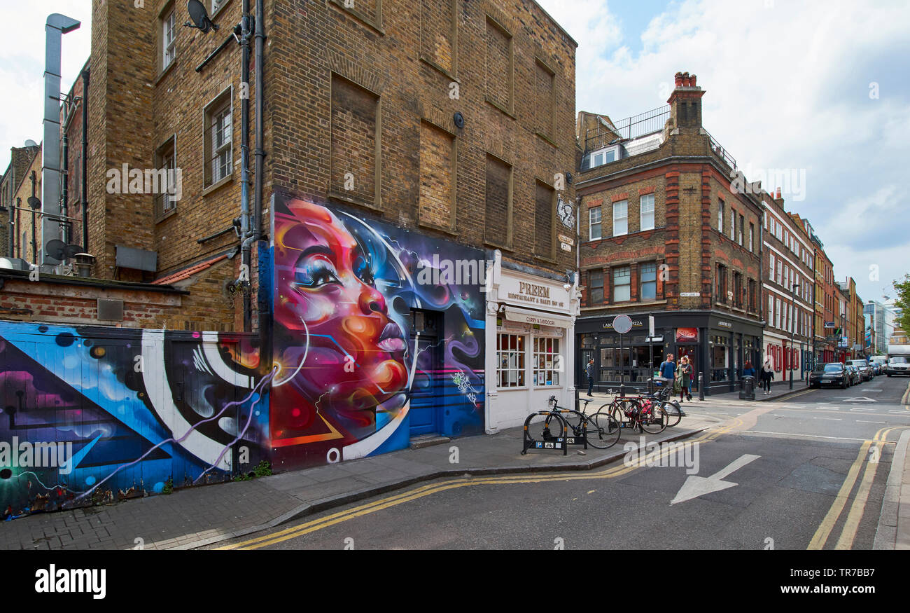 LONDON SPITALFIELDS BRICK LANE AREA GAFFITI AND WALL ART IN HANBURY STREET AND SEVERAL BRICK HOUSES Stock Photo