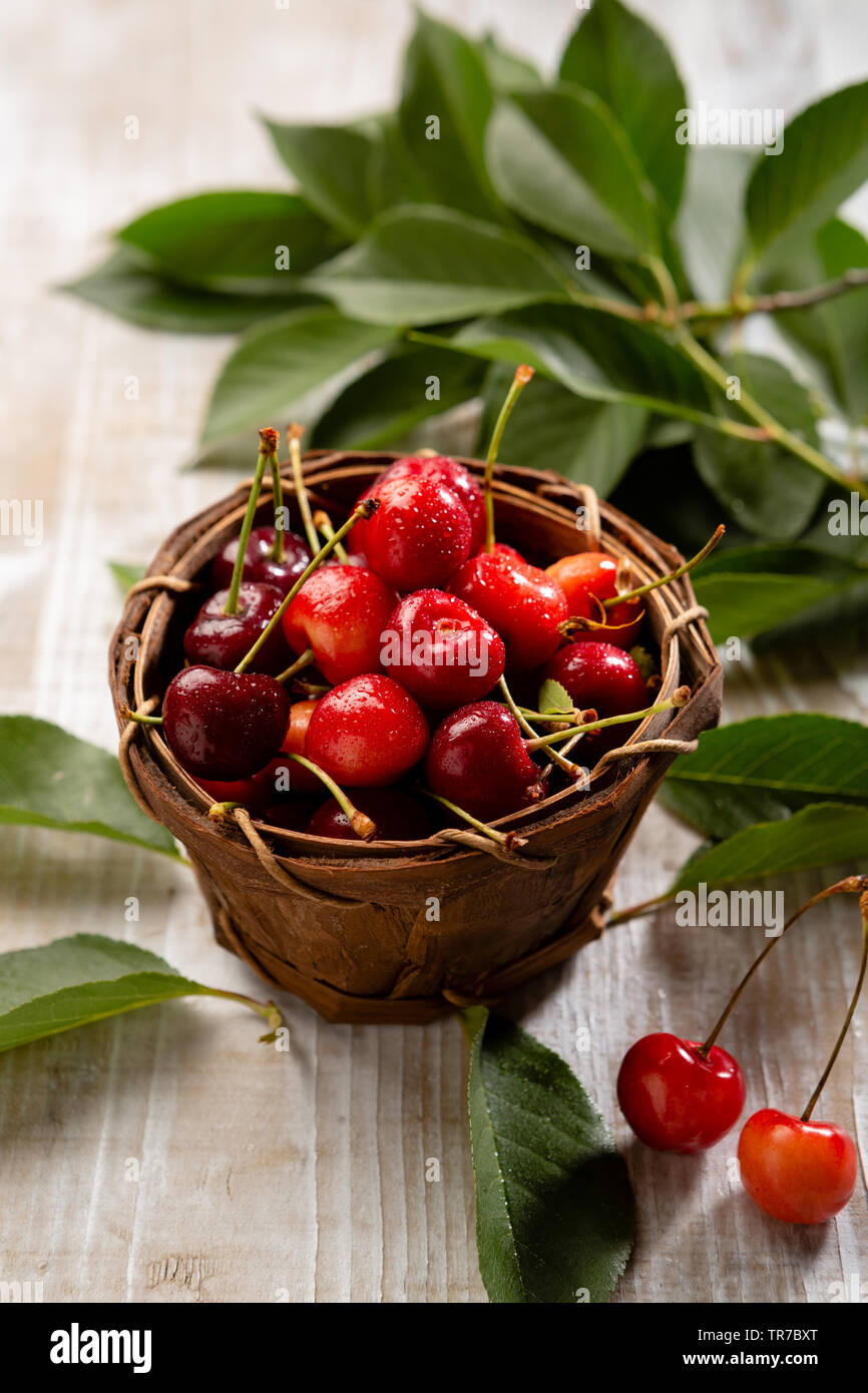 Cherry in wooden basket Stock Photo - Alamy