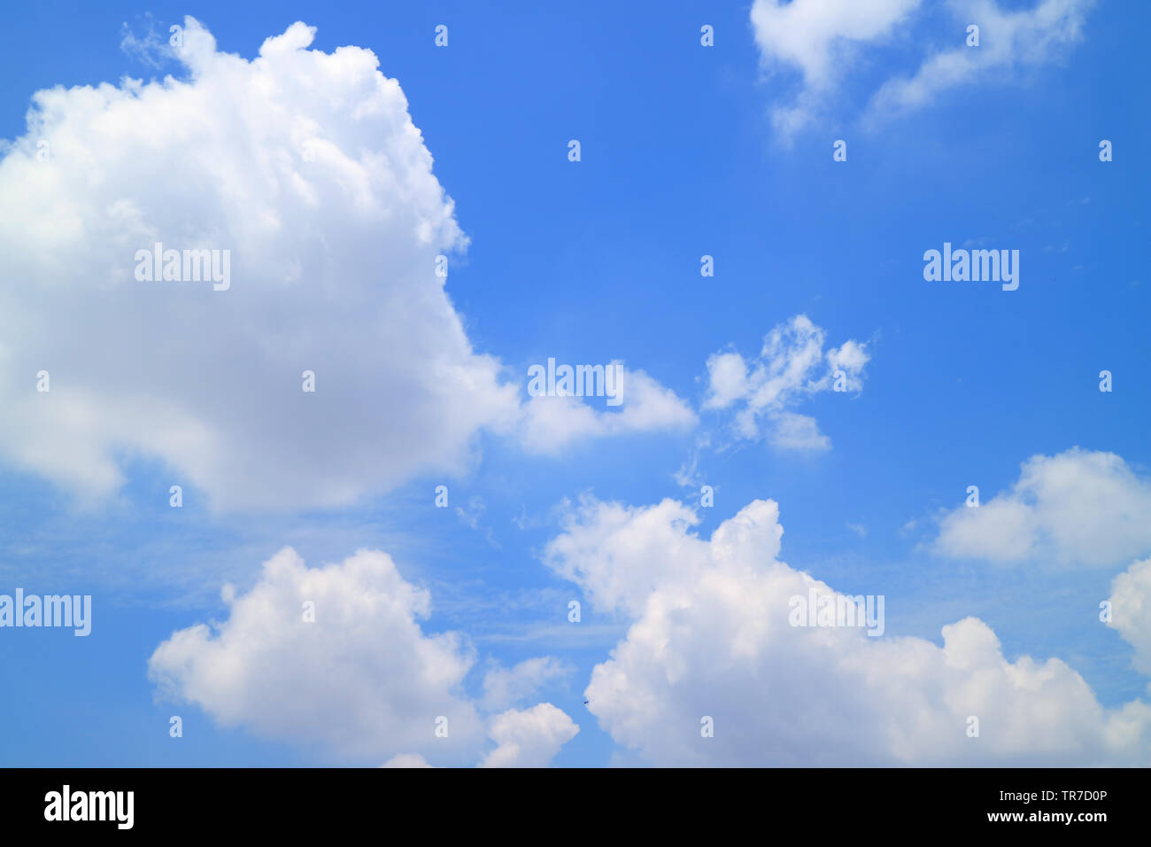 Vibrant sunny blue sky with white fluffy clouds Stock Photo - Alamy