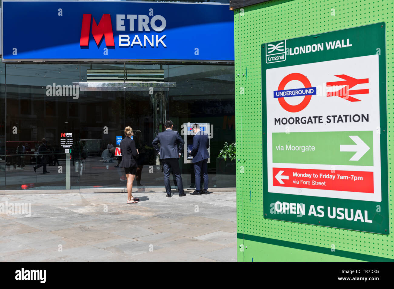 Customers outside a branch of Metro Bank in Moorgate, London, UK. Founded in 2010, shares in the bank have recently hit record lows. Stock Photo