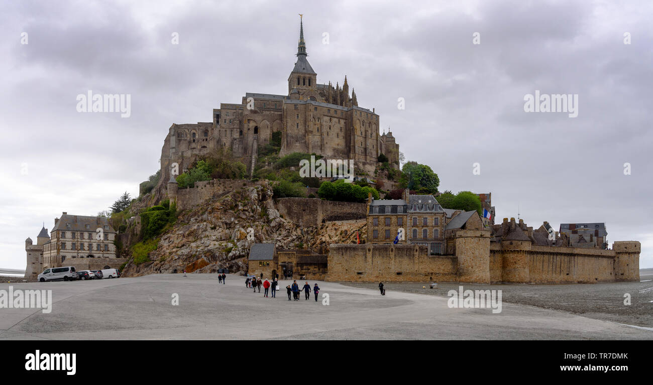 The parking lot at the end of the causeway before Le Mont-St-Michel on a cloudy day Stock Photo