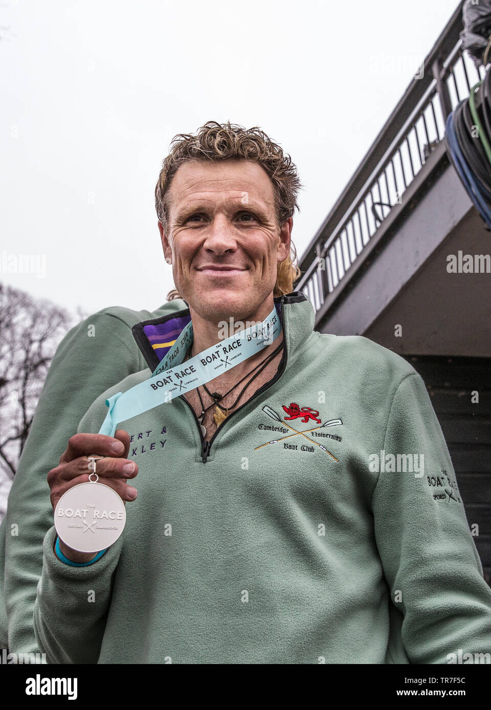 Olympic goldwinning rower James Cracknell holding his Cambridge v