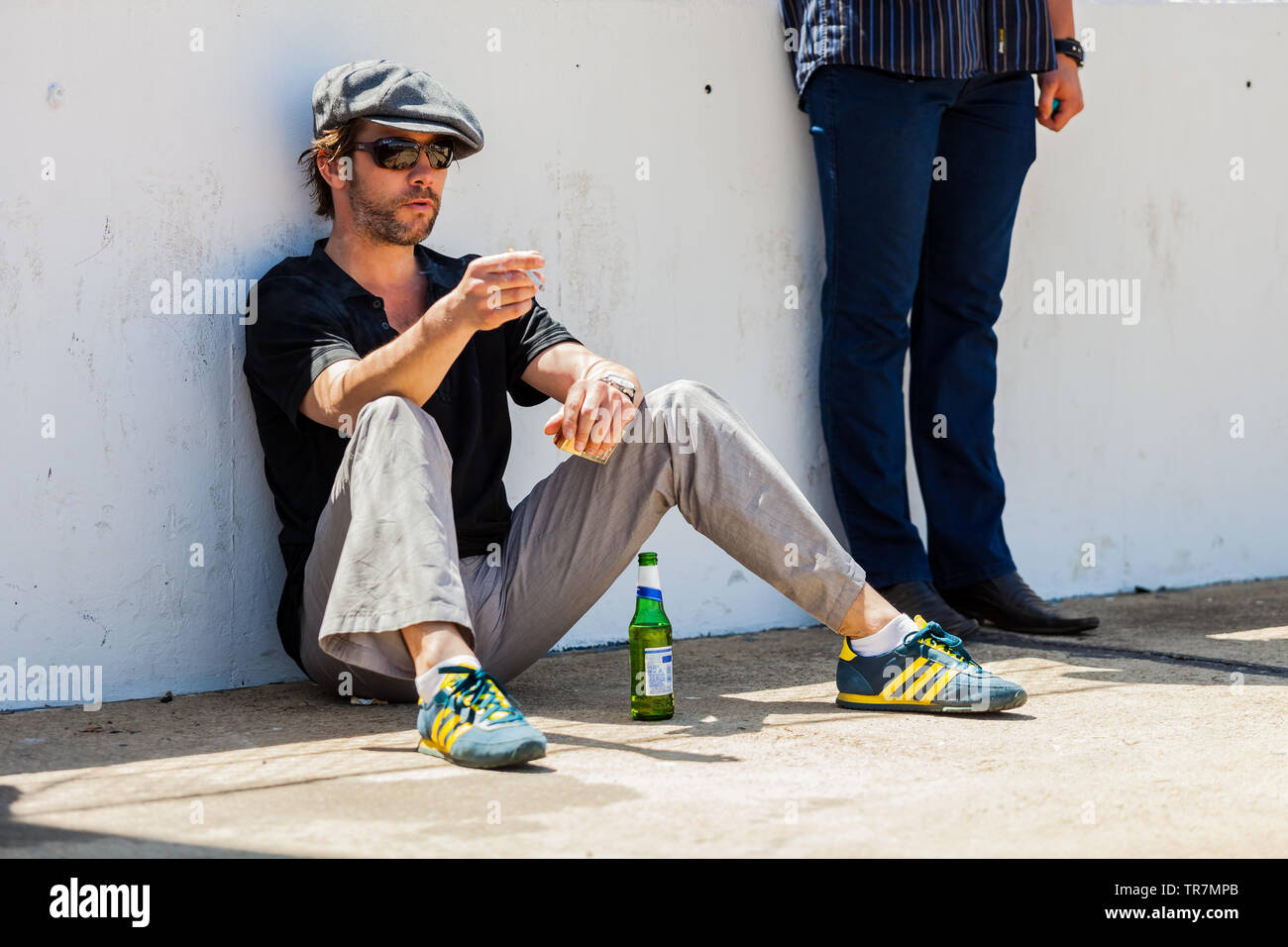 Johannesburg, South Africa - October 05 2013: Jay Kay of Jamiroquai  relaxing with a Cigarette next to a race track Stock Photo - Alamy