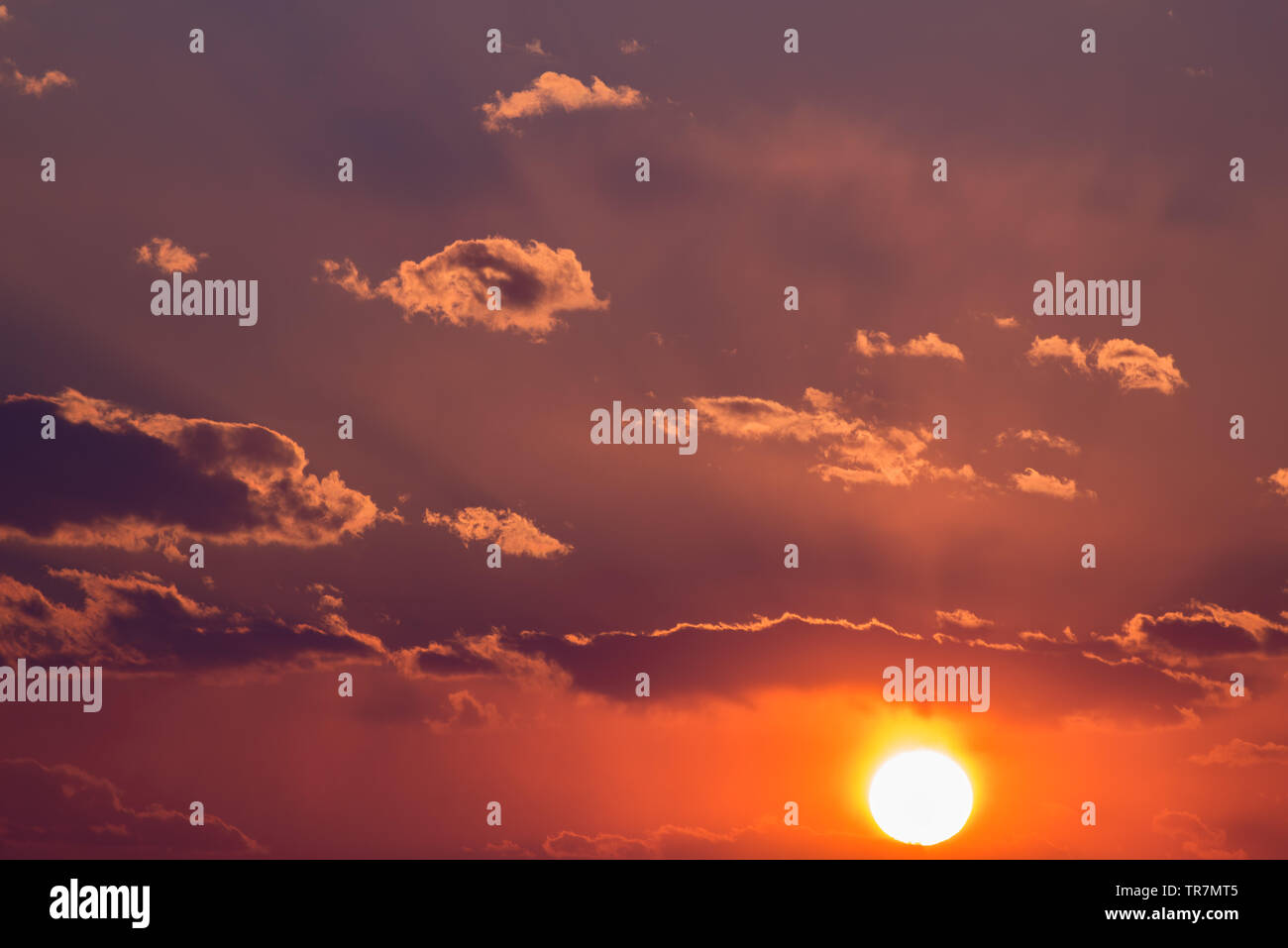 Dramatic sunset sky with orange colored clouds and sun Stock Photo - Alamy