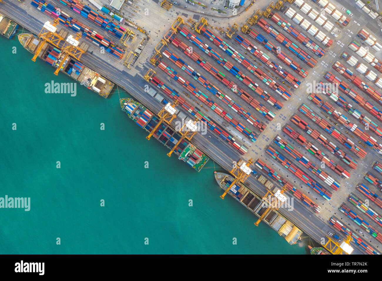Container ship in export and import business and logistics. Shipping cargo to harbor by crane. Water transport International. Aerial view Stock Photo