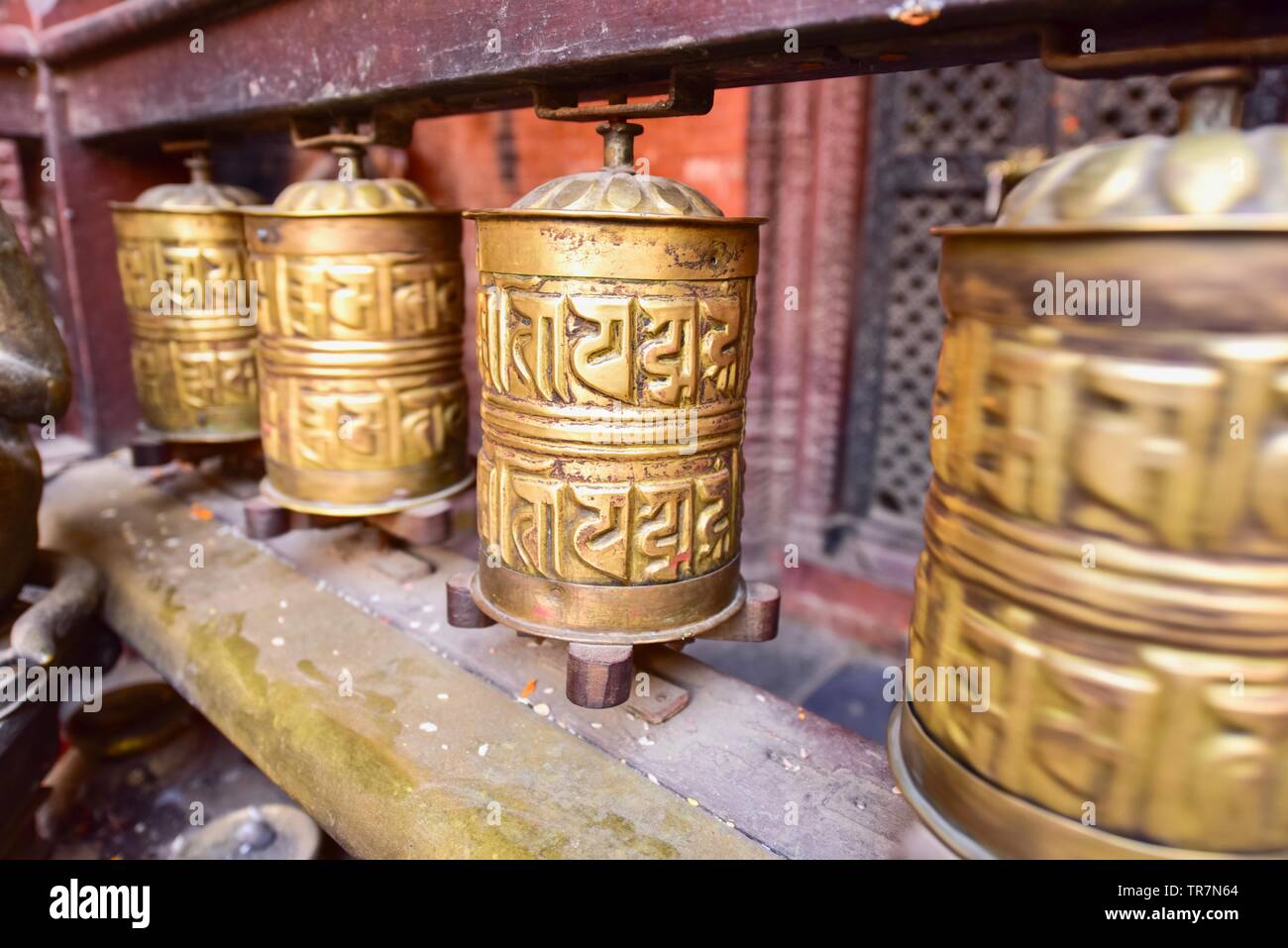 Golden Tibetan Prayer Wheels at Patan Golden Temple in Nepal Stock Photo