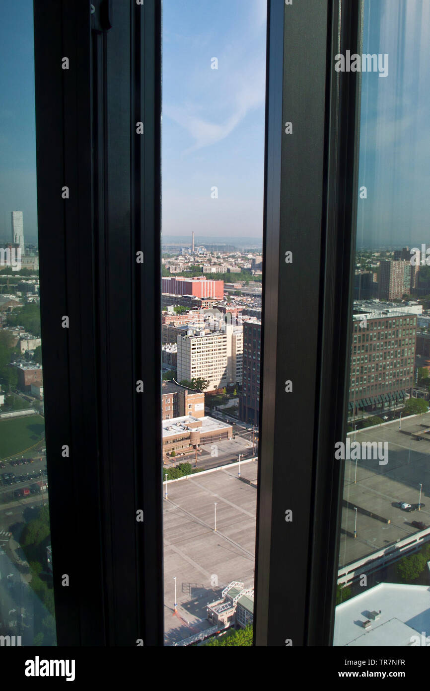 Looking out of a high rise building window across the sprawling conurbation of Jersey City, New Jersey, USA Stock Photo