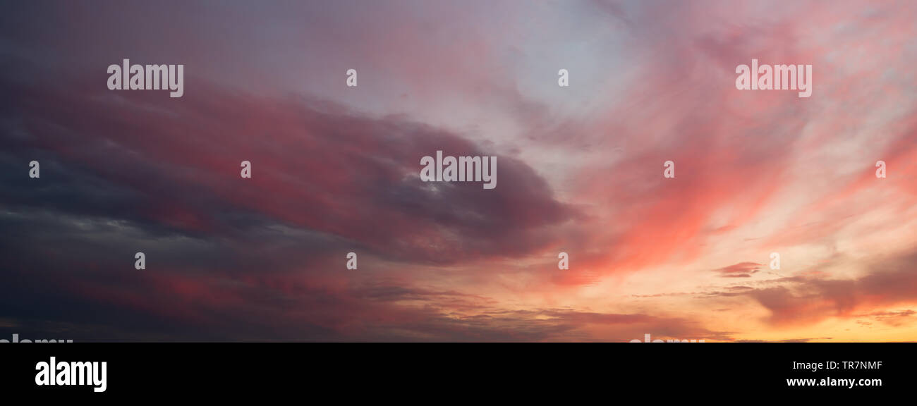 Dramatic sunset sky with orange colored clouds Stock Photo - Alamy