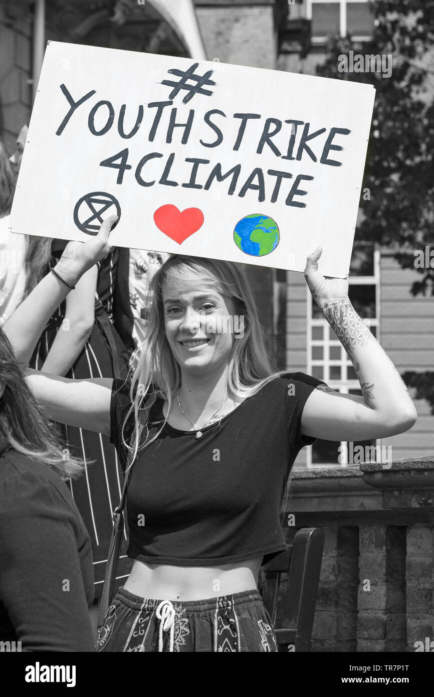 Young woman holding #youthstrike4climate banner sign at Youth Strike 4 Climate at Bournemouth, Dorset in May Stock Photo