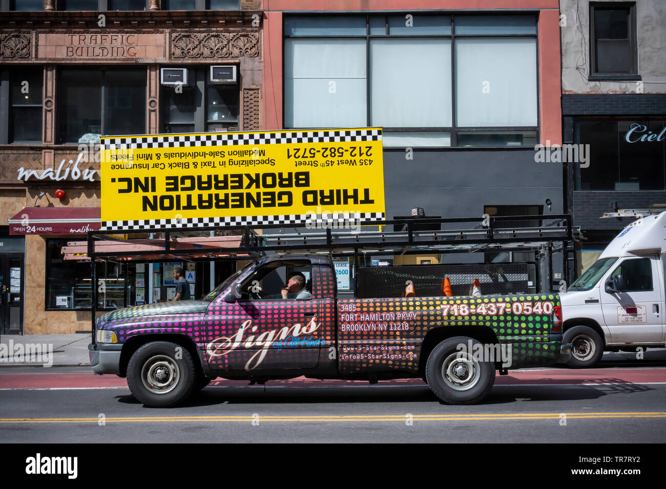 A sign maker on his way to install a sign for a taxi medallion broker in New York on Wednesday, May 22, 2019. Following an investigation by the New York Times the NYS Attorney General has launched a probe into the taxi medallion business and its loan practices. (© Richard B. Levine) Stock Photo