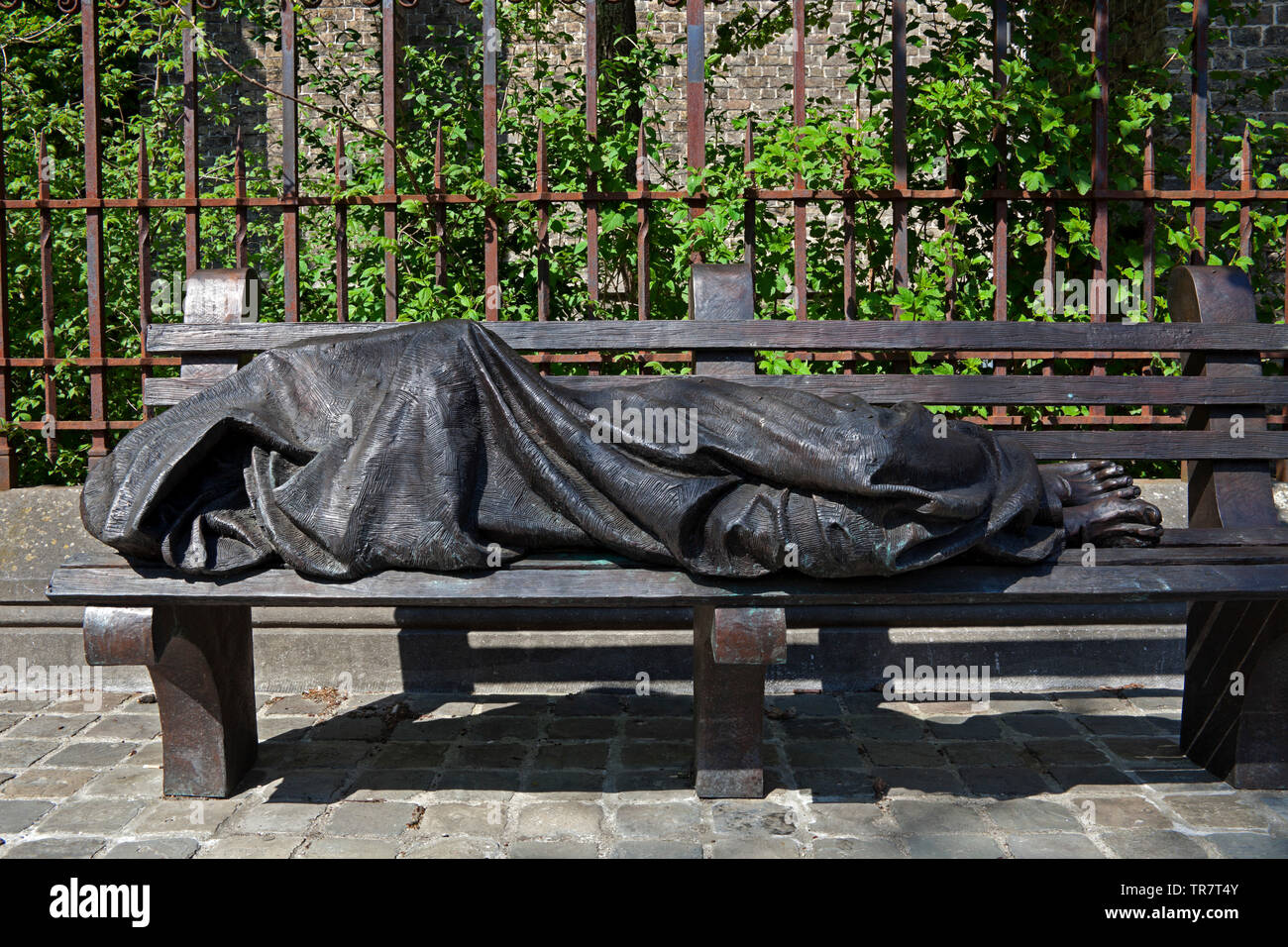 Bruges, Homeless Jesus, bronze statue, Stalijzerstraat, Belgium, Europe Stock Photo