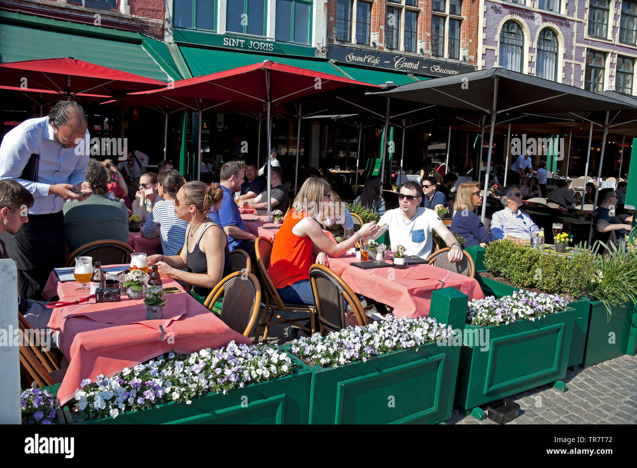 People eating and drinking at cafe bar, Bruges, Belgium, Europe Stock Photo