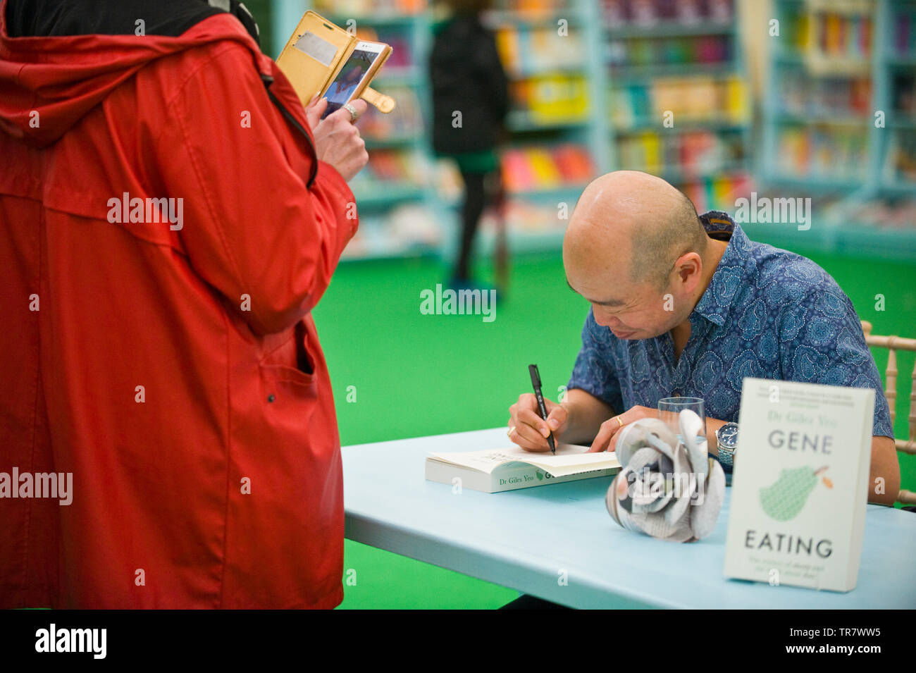 Dr Giles Yeo geneticist book signing for fans in the bookshop at Hay Festival Hay on Wye Powys Wales UK Stock Photo