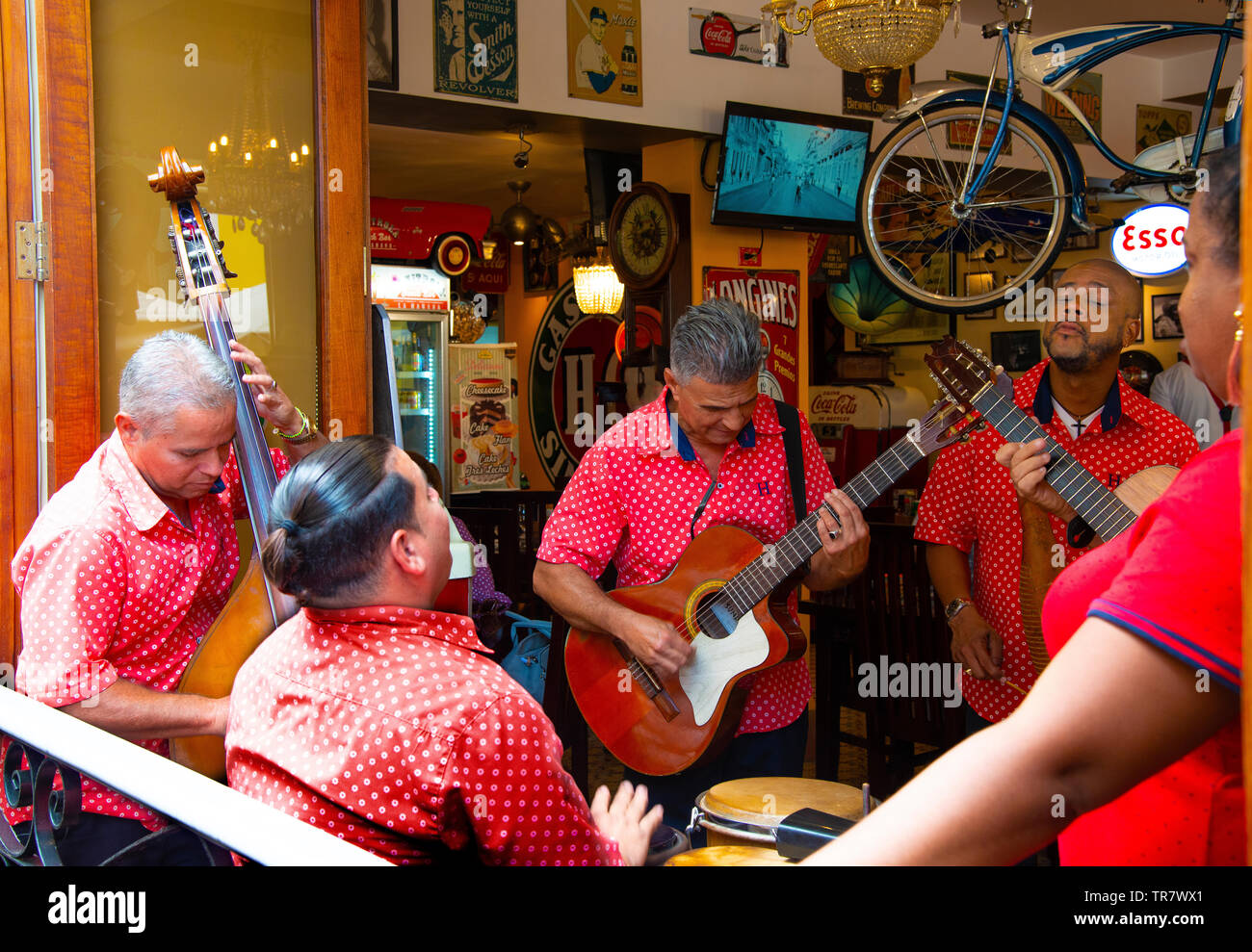 Band plays music street side in an open-sided restaurant adjacent to Plaza Vieja, Havana, Cuba, Caribbean Stock Photo