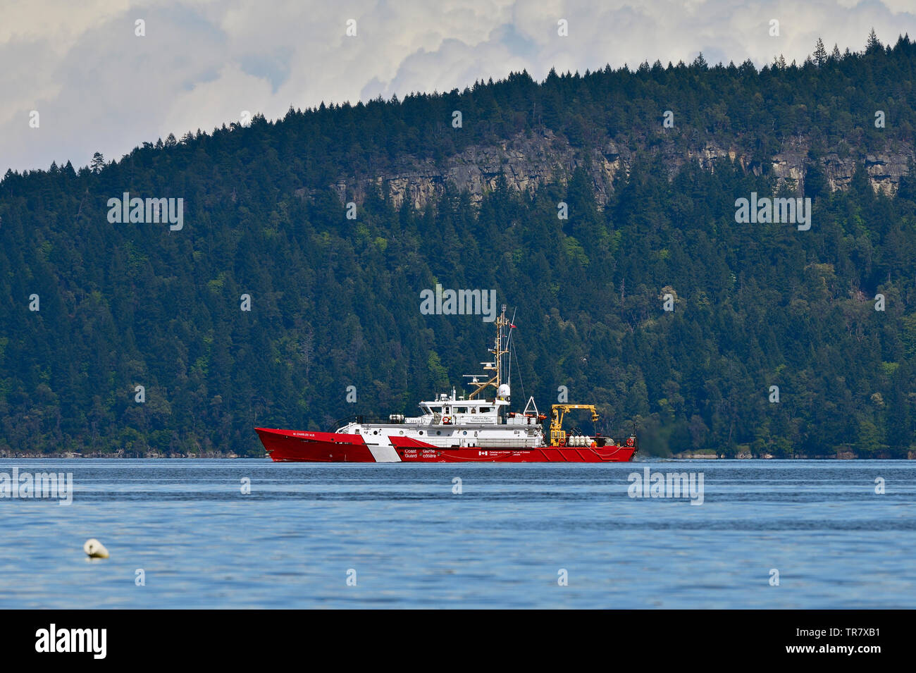 A Canadian Coast Guard fisheries patrol vessel traveling on the waters of The Strait of Georgia near Vancouver Island British Columbia Canada. Stock Photo
