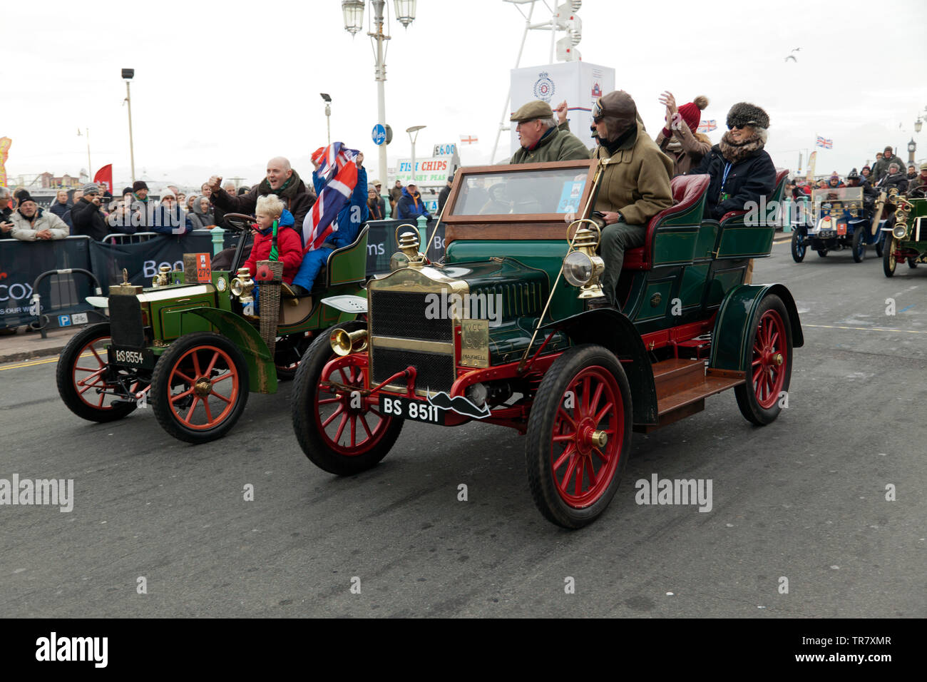 A 1904 Maxwell (centre) and a 1904 Peugeot (left), cross the finishing line together at the end of the 2018 London to Brighton Veteran Car Run Stock Photo