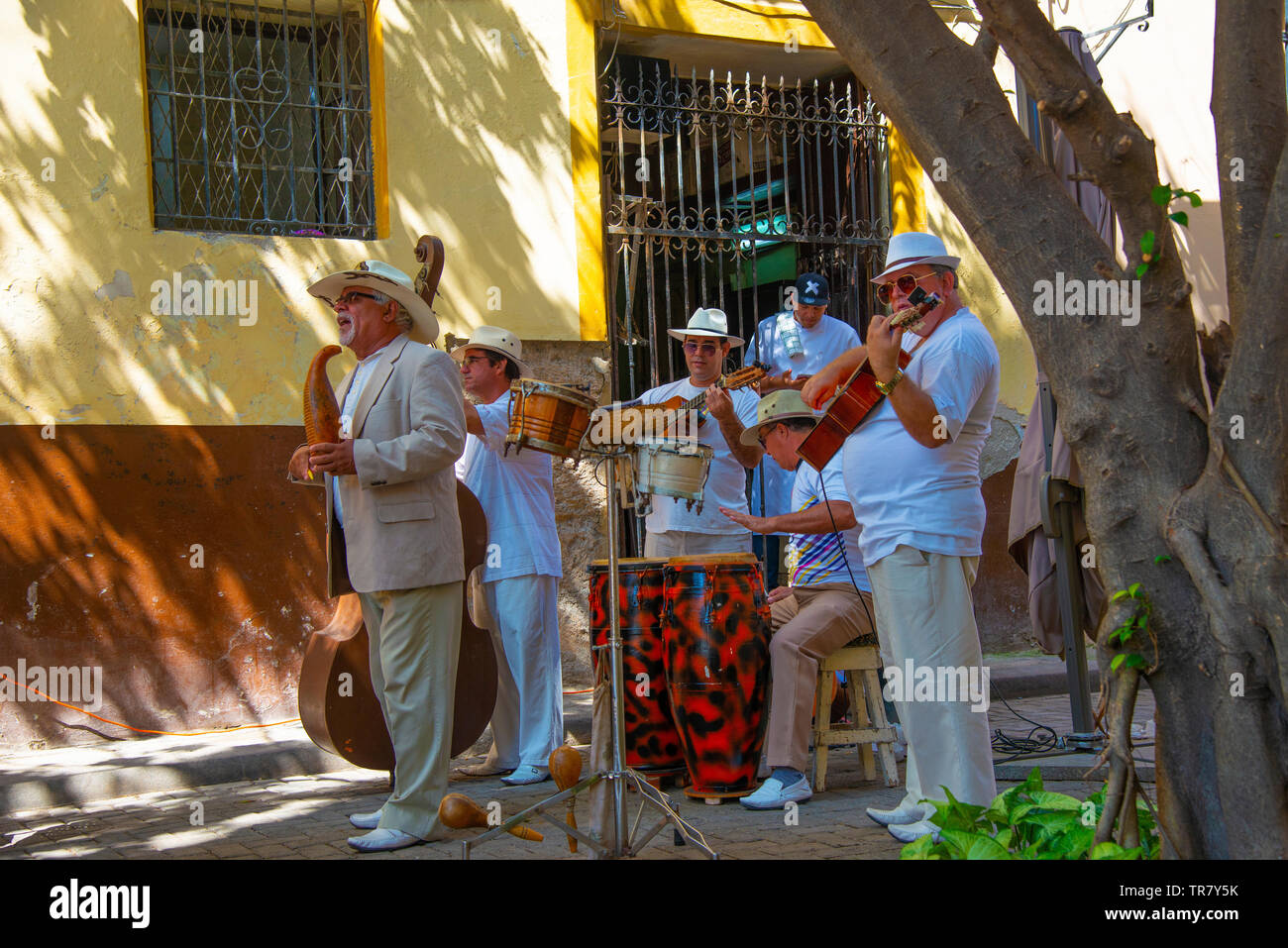 Cuban band plays salsa music in the sunshine in Habana Vieja (old town), Havana, Cuba, Caribbean Stock Photo