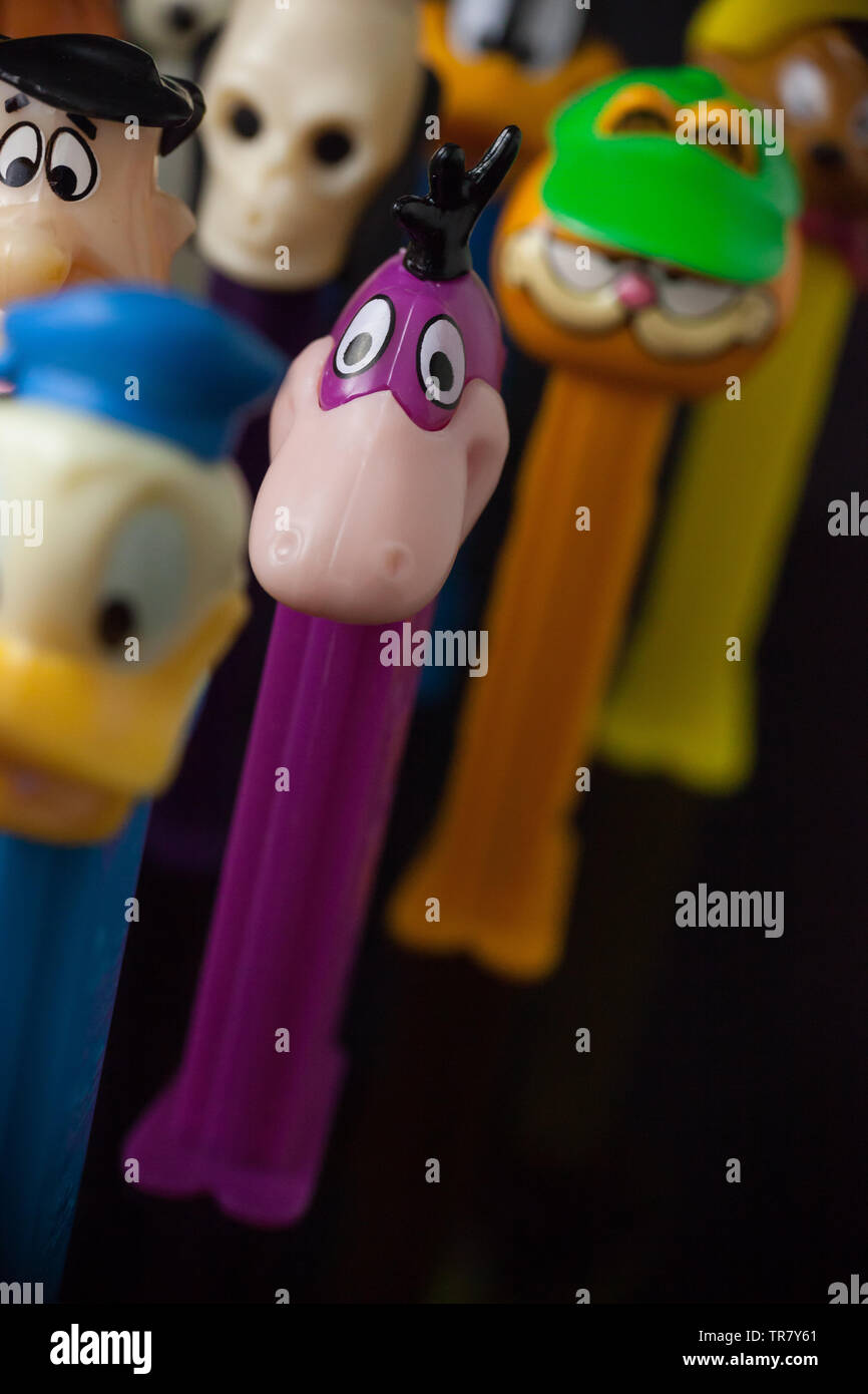 WOODBRIDGE, NEW JERSEY / UNITED STATES: May 12, 2019: Colorful Pez dispensers from the 1980s and 1990s are seen against a black background Stock Photo