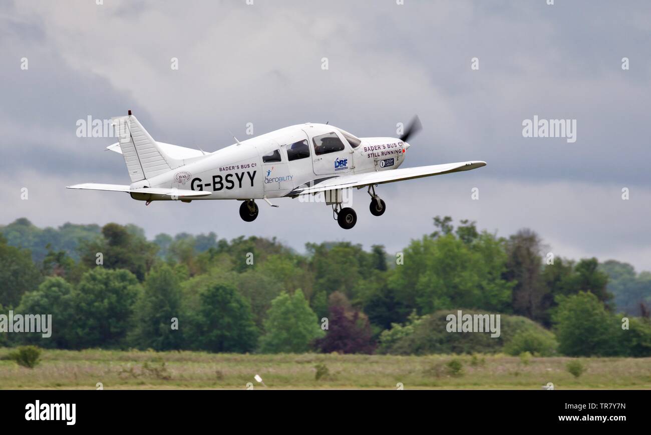 The Bader’s Bus Company Display Team - Piper PA-28 Warrior () taking off at the 2019 Duxford Air Festival Stock Photo