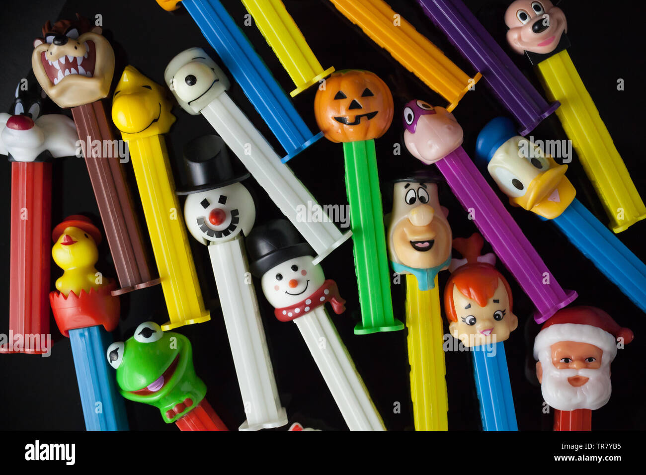 WOODBRIDGE, NEW JERSEY / UNITED STATES: May 12, 2019: Colorful Pez dispensers from the 1980s and 1990s are seen against a black background Stock Photo