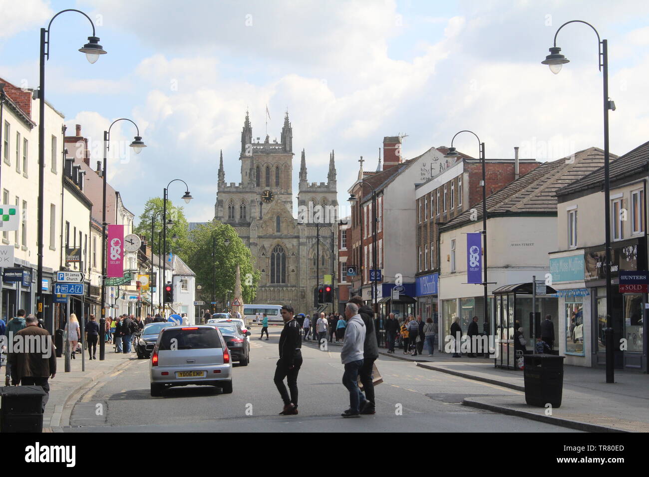 Typical view of British high street Selby North Yorkshire with a view of Selby Abbey on spring day Stock Photo