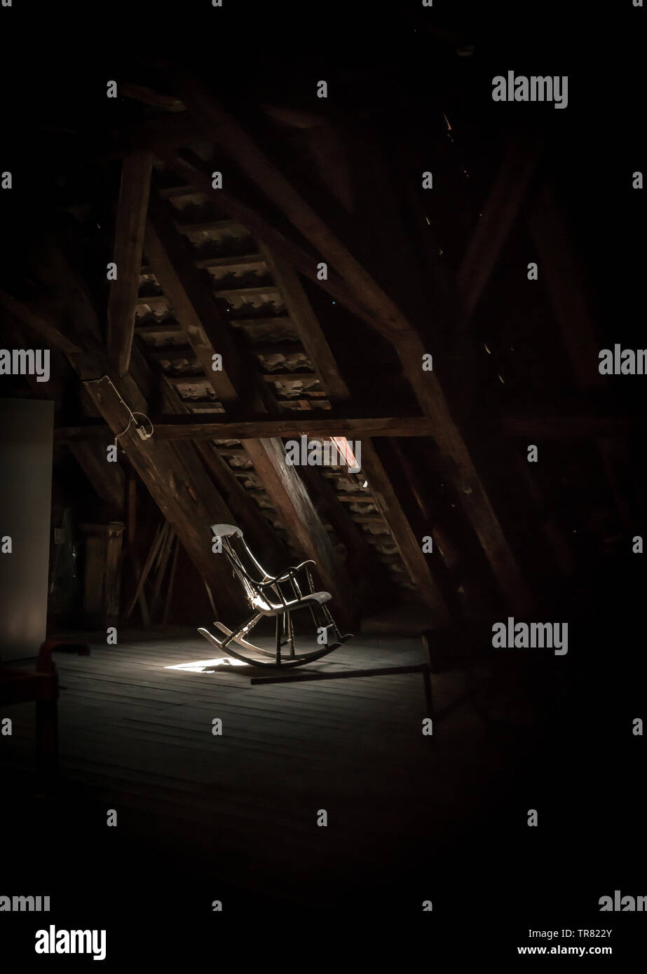Lonely wooden rocking chair on a loft Stock Photo - Alamy