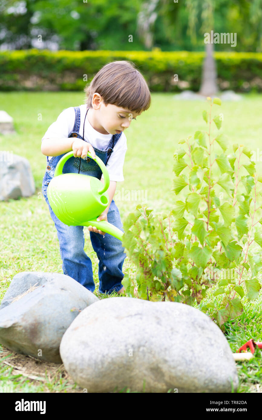 Boy watering plants hi-res stock photography and images - Alamy