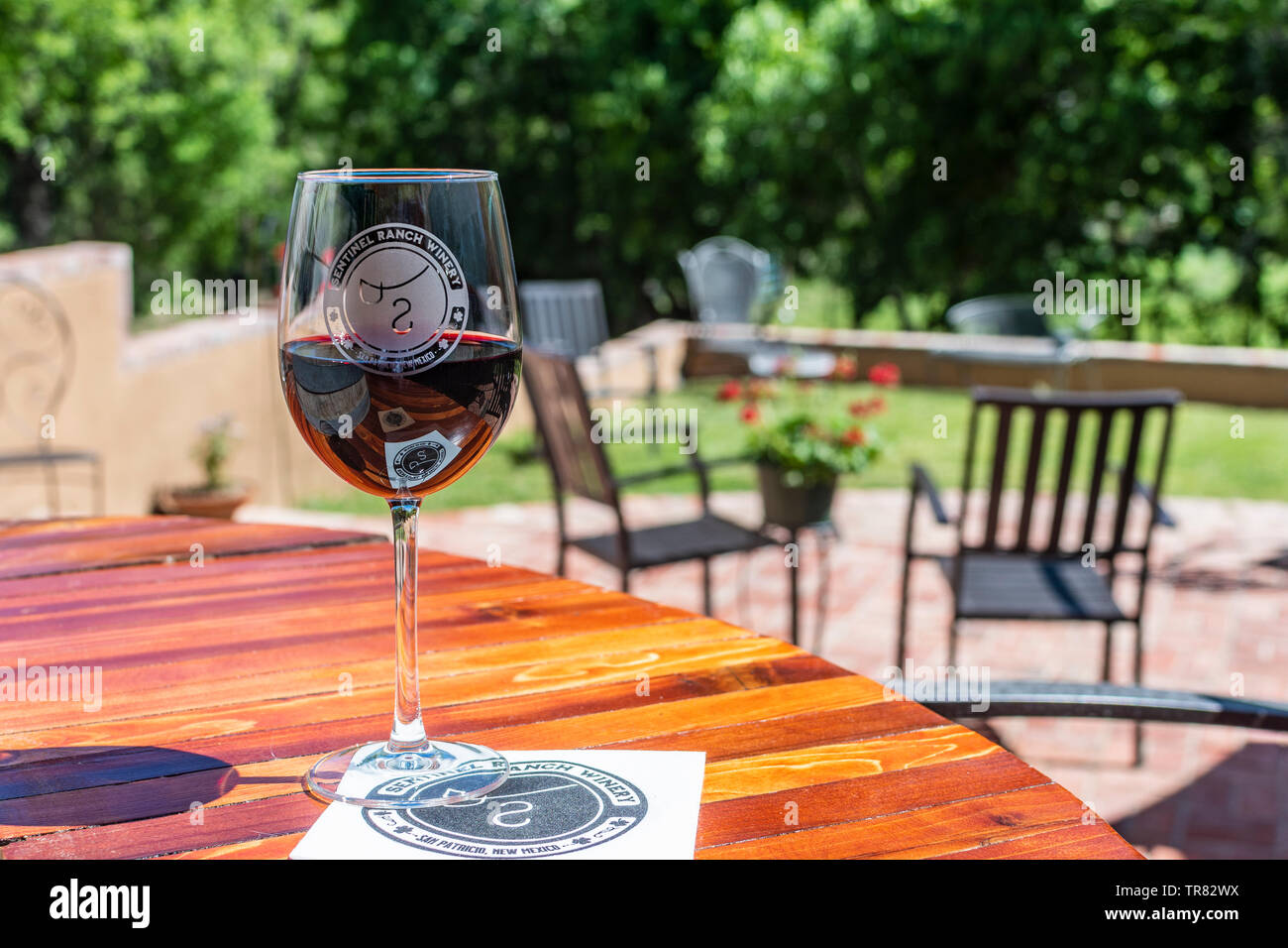 Sentinel Ranch Winery, red wine in a glass on an outdoor table in San Patricio, New Mexico, USA. Stock Photo