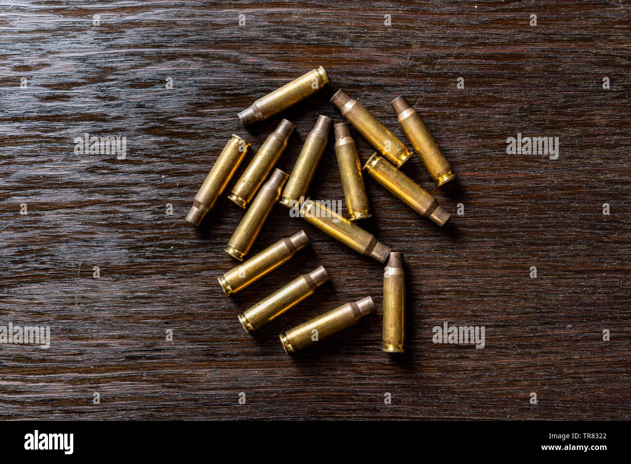 Empty bullet casings on a dark, wooden table Stock Photo ...