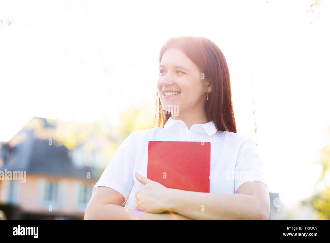 Girl student walking holding book hi-res stock photography and images ...