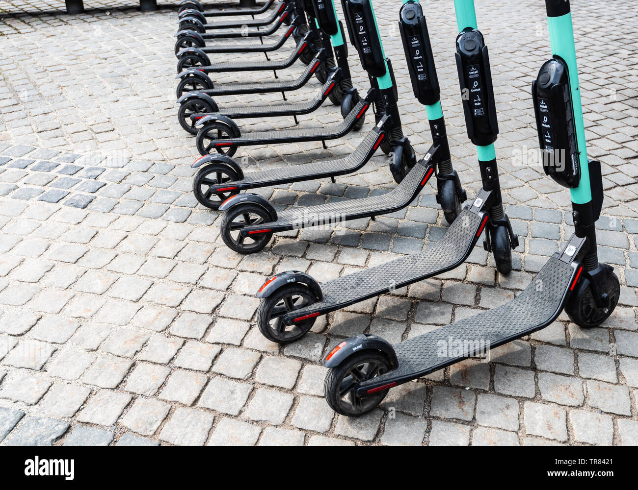 Electric scooters neatly parked and ready for hire Stock Photo Alamy