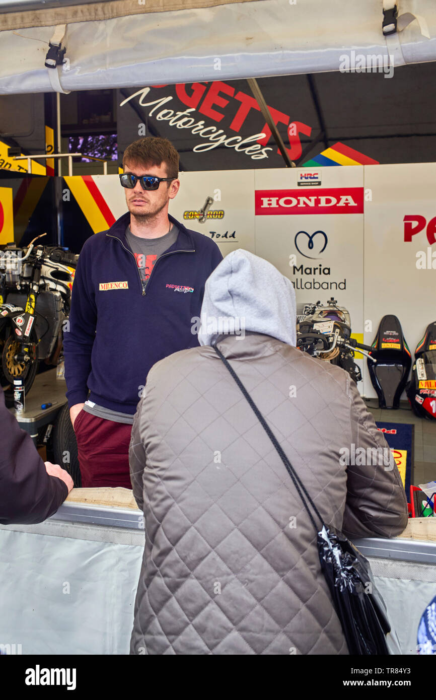 Conor Cummings chats to members of the pubic from the Pagetts motorcycles race preparation area at the Grandstand prior to 2019 TT races Stock Photo