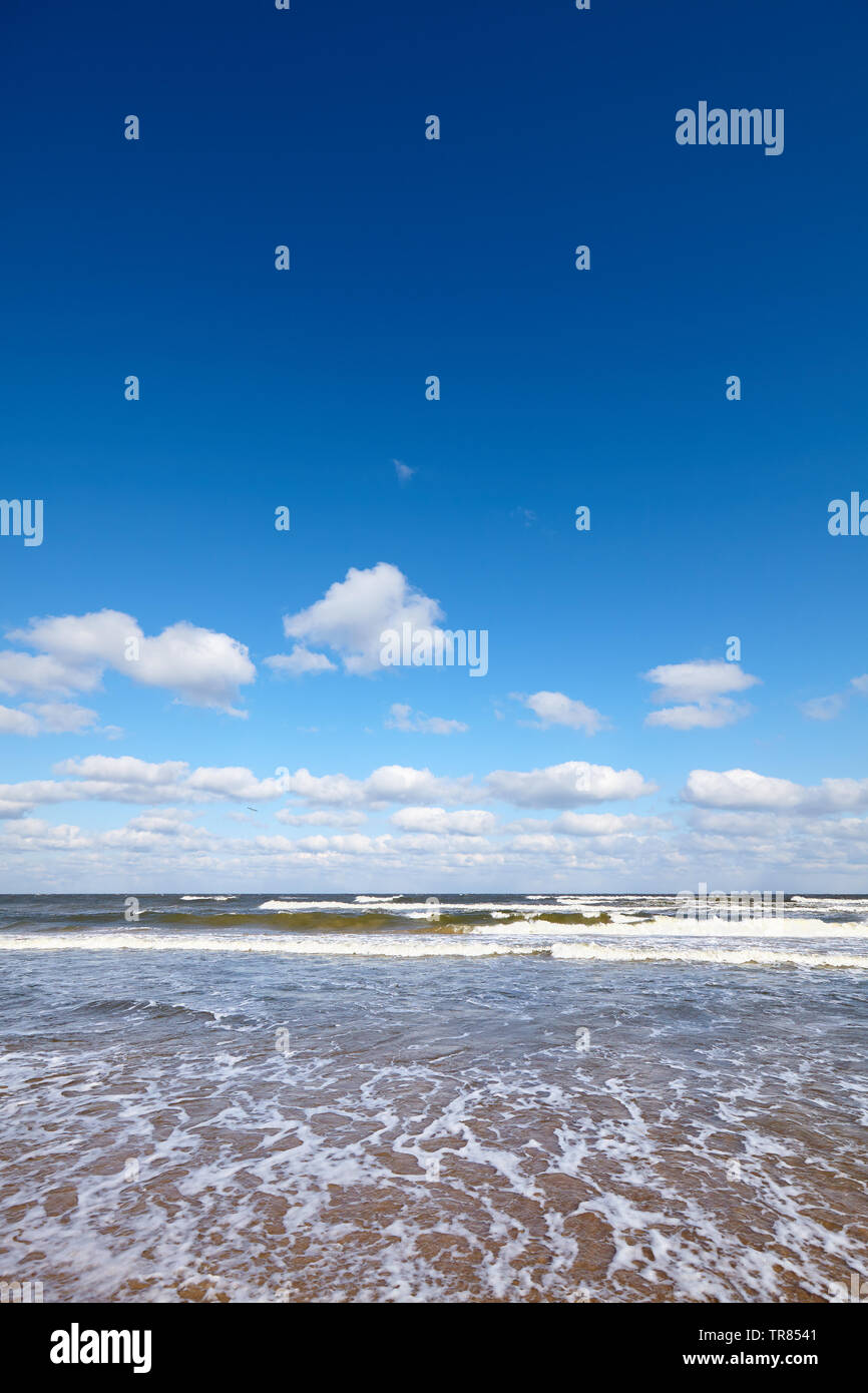 Seascape with layer of clouds and blue cloudless sky. Stock Photo