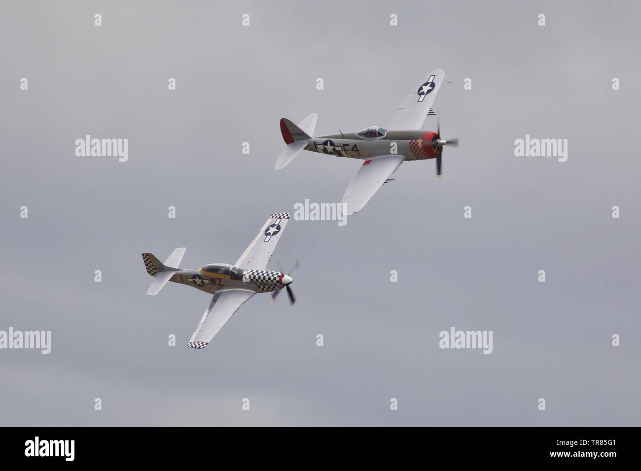 Republic P-47D Thunderbolt and a North American P-51D Mustang performing a special flypast to commemorate the 75th anniversary of D-Day Stock Photo