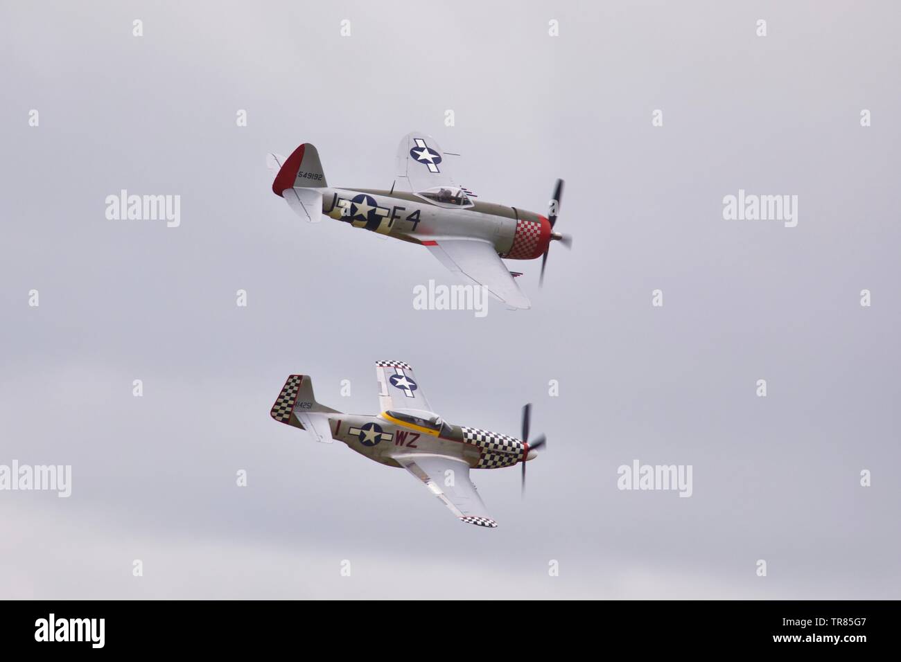Republic P-47D Thunderbolt and a North American P-51D Mustang performing a special flypast to commemorate the 75th anniversary of D-Day Stock Photo