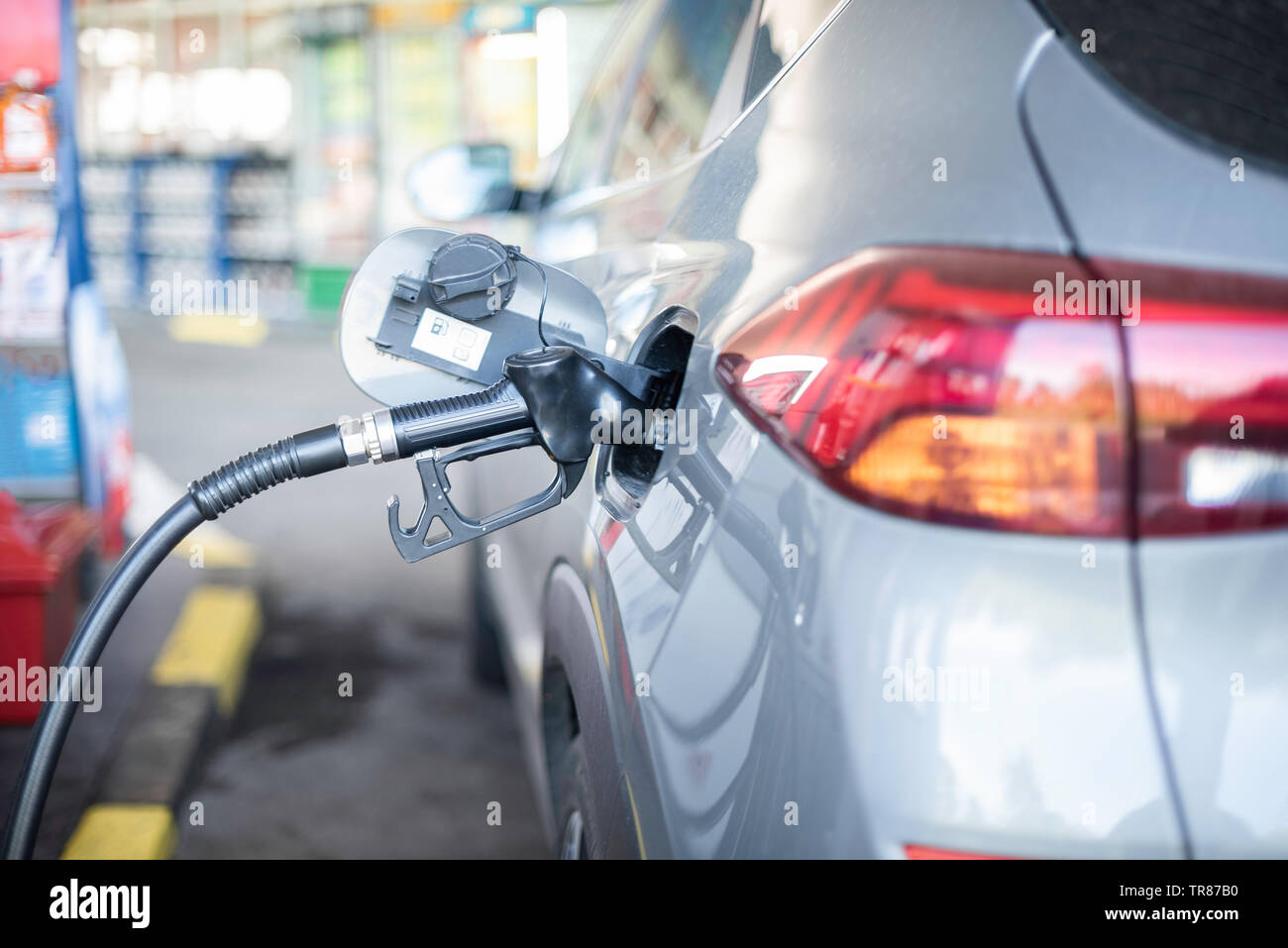 Refueling refilling car vehicle with fuel at refuel fuel gas pump