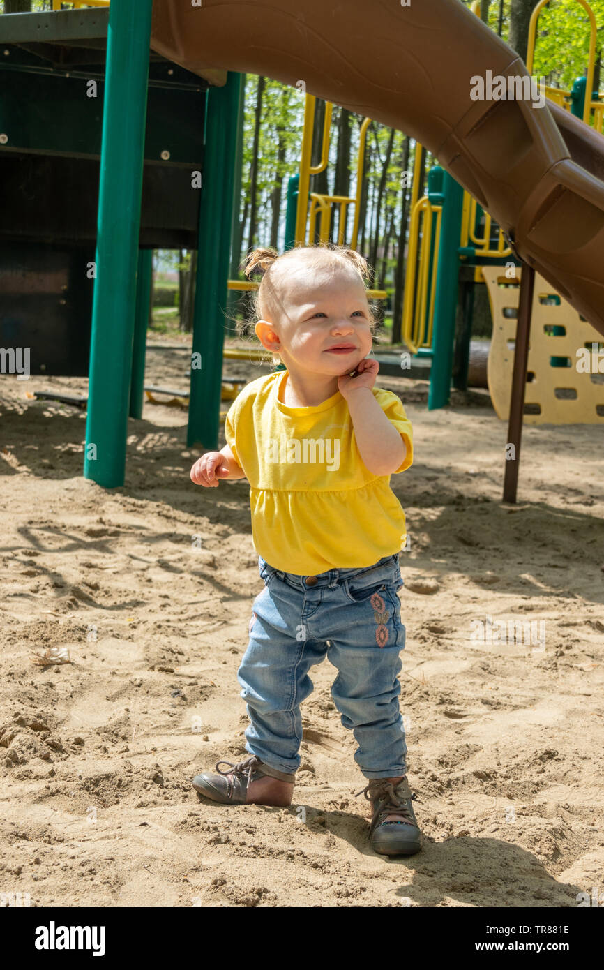 15 month old adorable blond caucasian toddler playing on sand box at the public park outdoor Sorel-Tracy Quebec Canada Stock Photo