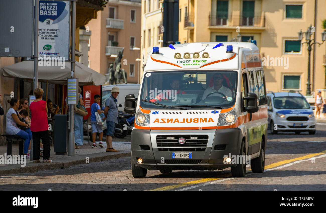 VERONA, ITALY - SEPTEMBER 2018: Ambulance on an emergency call driving at speed along a street in the centre of Verona. Stock Photo