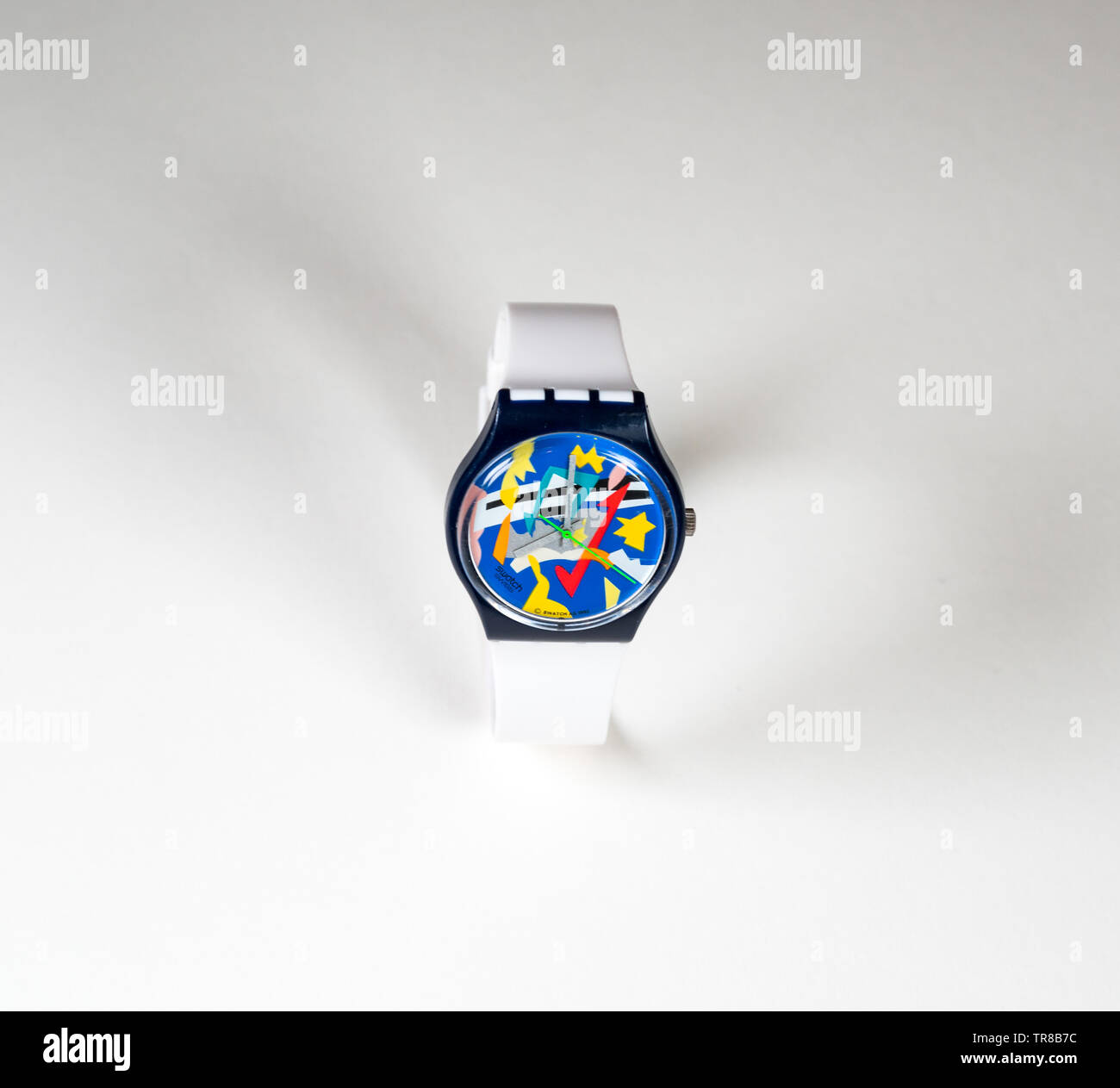 Colorful 1990's Swatch watch with white band on a plain white background. Stock Photo