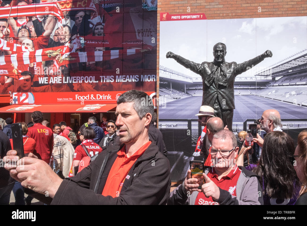 Liverpool Football Club,LFC,supporters,fans,selfie,at,Bill Shankly,statue,Anfield,Stadium,prior,to,last,game,of,the,season,v Wolves.Liverpool,England, Stock Photo