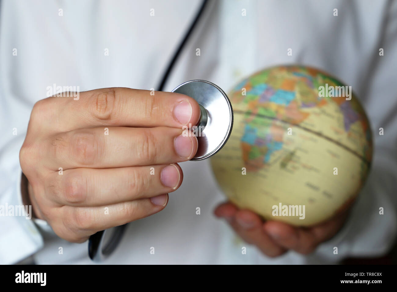 Health care in Africa, doctor with stethoscope and globe in his hand. Concept of medical network and world medicine, epidemic control, medical tourism Stock Photo
