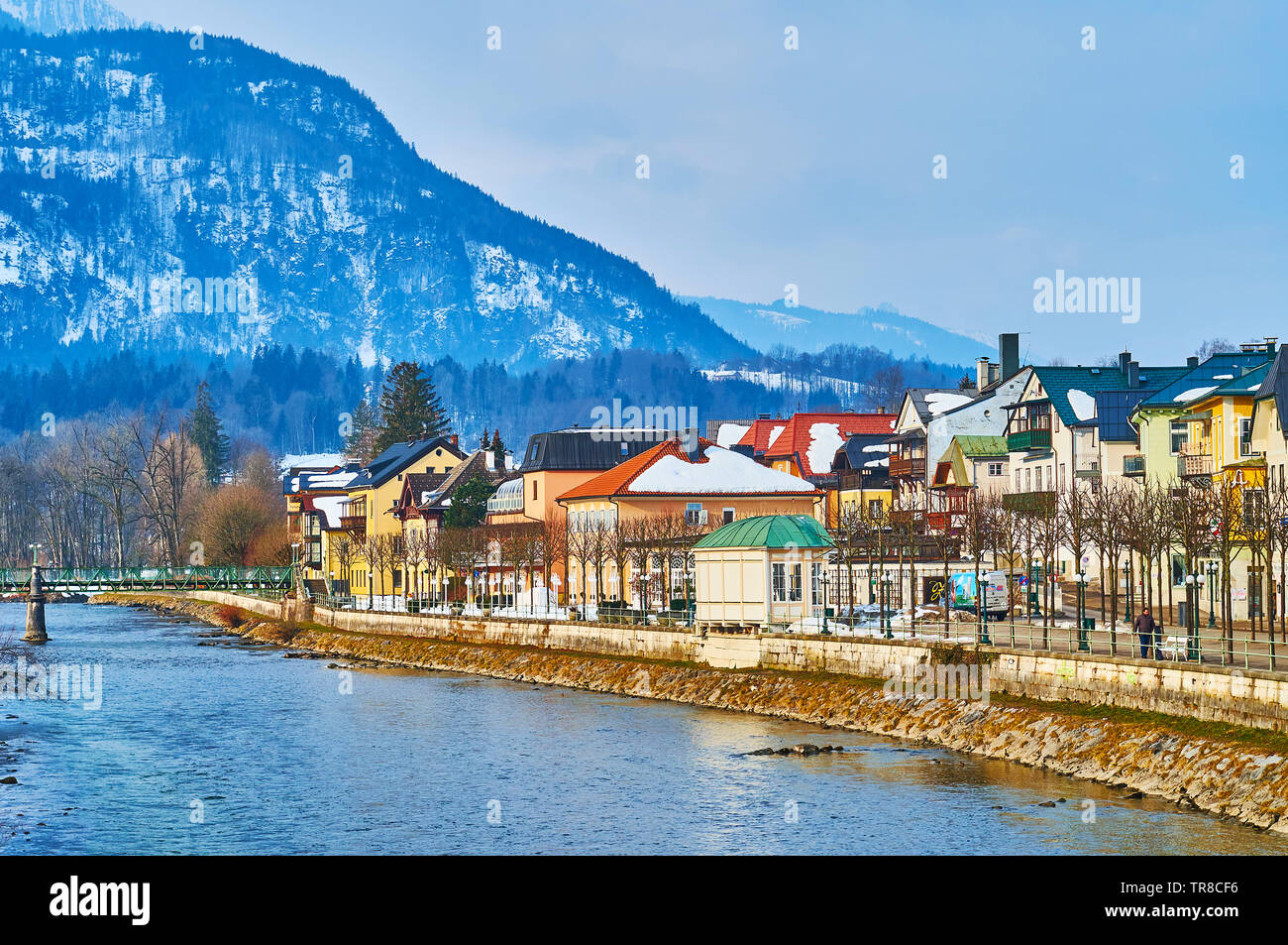 BAD ISCHL, AUSTRIA - FEBRUARY 20, 2019: Esplanade embankment of Traun river with a view on historic quarters, colorful townhouses, souvenir stores and Stock Photo