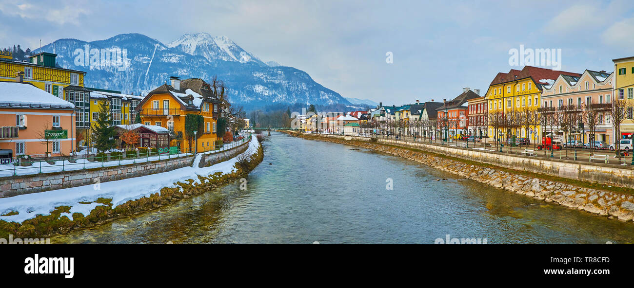 BAD ISCHL, AUSTRIA - FEBRUARY 20, 2019: Enjoy the riverside panorama with historic edifices along the banks and snowy Mount Katrin, dominating the tow Stock Photo