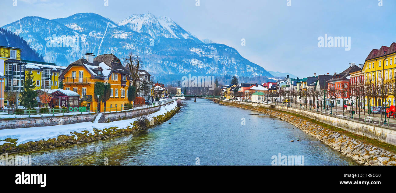 The Mount Katrin dominates the skyline of Bad Ischl, its snowy peak and white line of cable car are seen from the bridges over the Traun river, Salzka Stock Photo