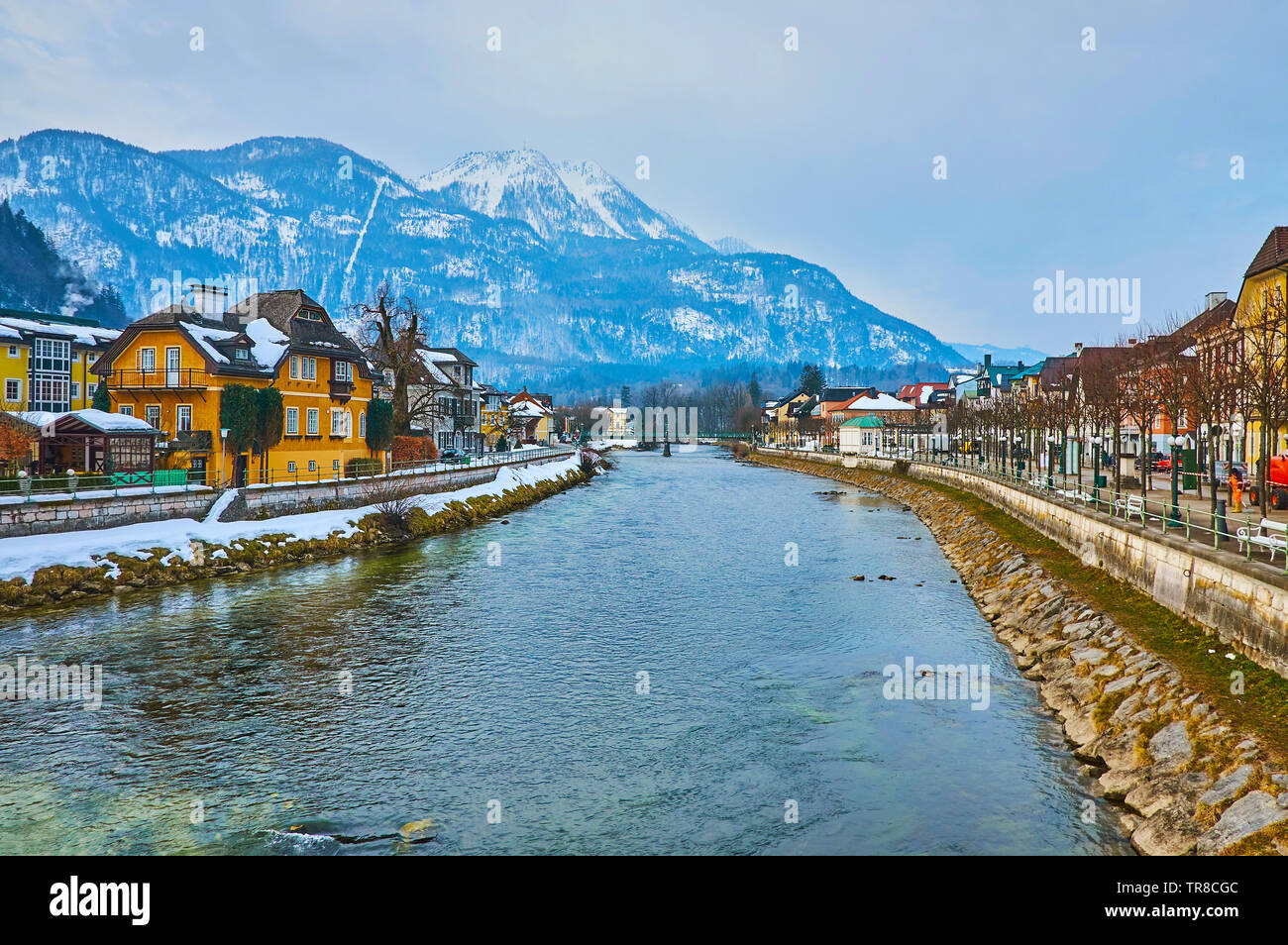 The picturesque Alpine scenery with snowy Mount Katrin from the Traun river, lined with histroical edifices of Bad Ischl, Salzkammergut, Austria. Stock Photo