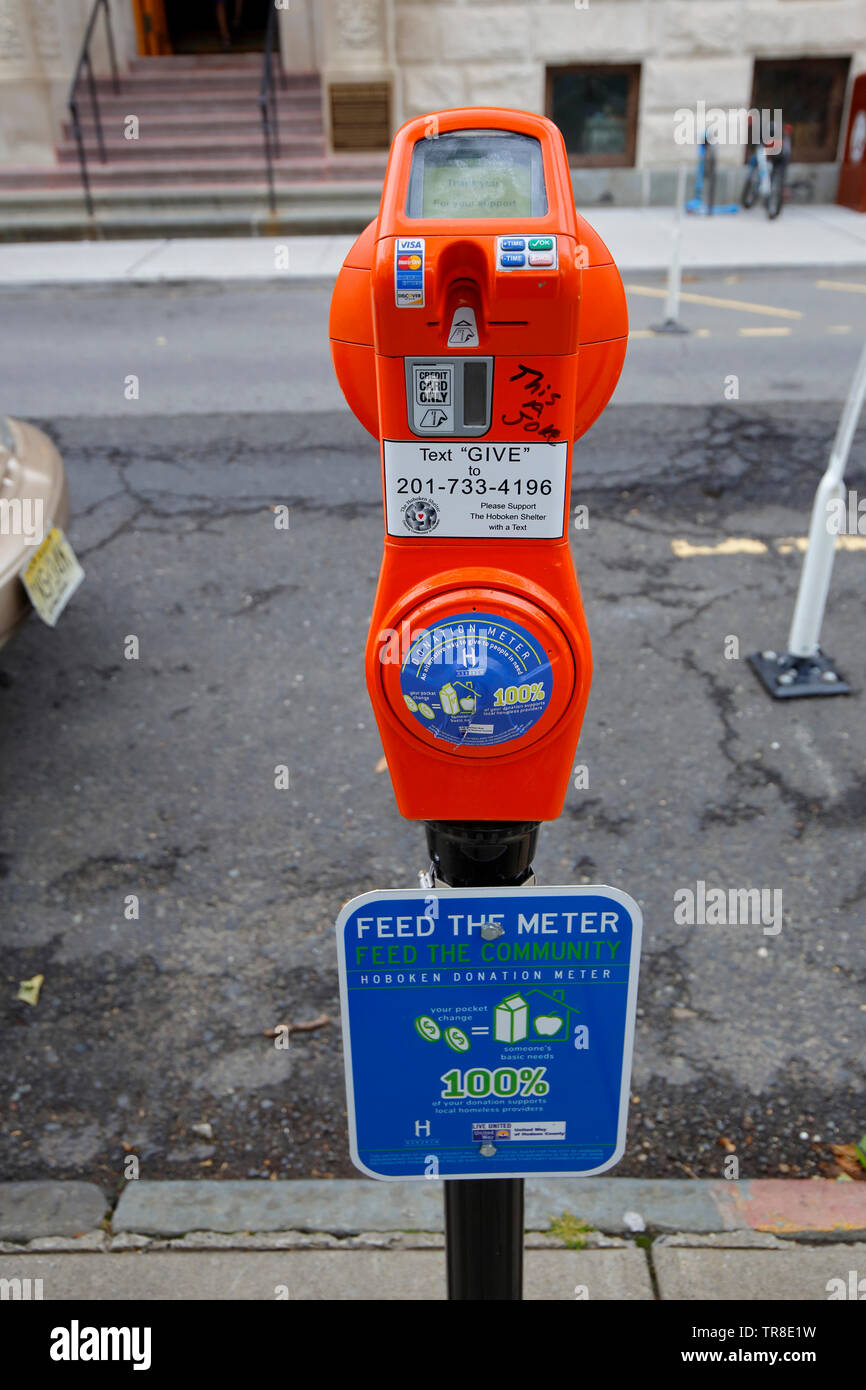 A 'Donation Meter', almsgiving in the form of a parking meter, on a street in Hoboken, New Jersey Stock Photo