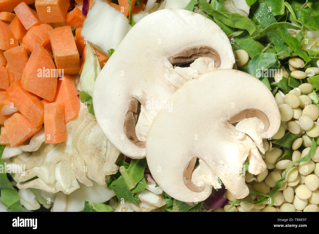 Various chopped vegetables, carrot, cabbage, lettuce, lentils, mushroom. Top view Stock Photo