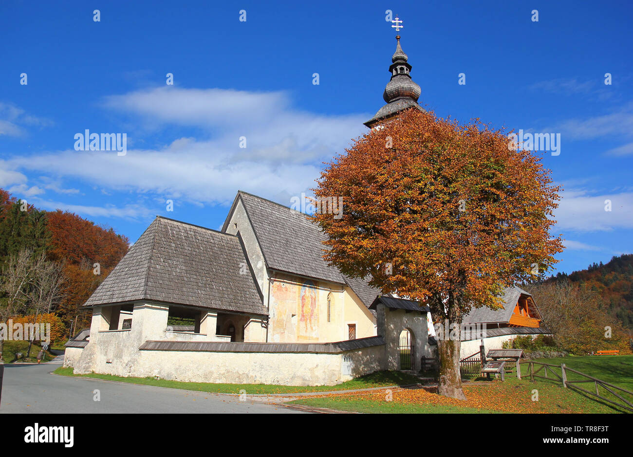 Gothic church of Saint John at Bohinj lake in colours of autumn, Ribcev laz, Juliana Walking trail, Triglav National Park, Slovenia, Central Europe Stock Photo