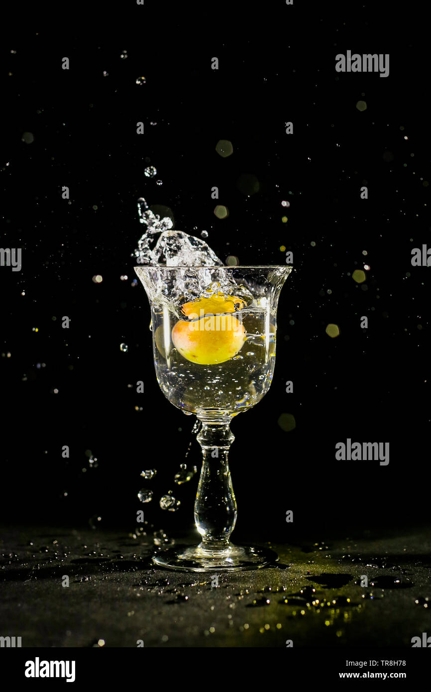 throw grapes in a waterfilled glass and splash Stock Photo Alamy